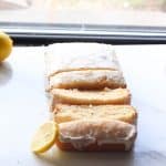 vegan lemon cake in slices by the window with a slice lemon