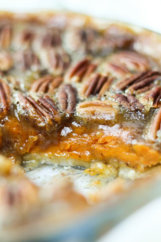sweet potato pecan pie sliced through to show the both layers of the filling
