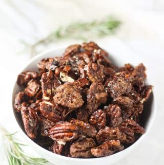 vegan candied pecans in a white bowl