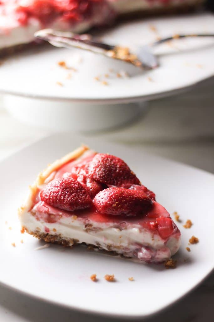 slice of strawberry vegan cheesecake on a plate