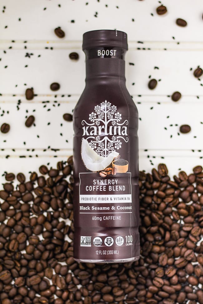 Karuna Bottle surrounded by coffee beans