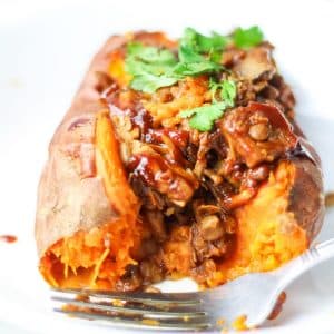 sweet potato cut open stuffed with lentils, mushrooms, jackfruit and BBQ sauce
