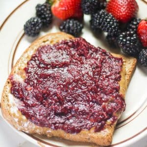 blackberry jam spread over walnut butter and bread