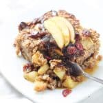 baked oatmeal topped with sliced apples with fork