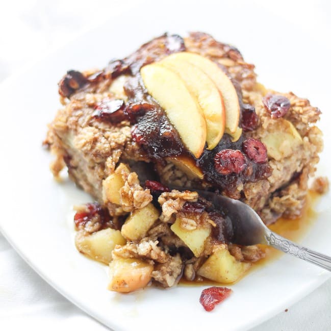 baked oatmeal topped with sliced apples with fork