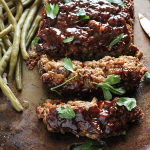 vegan meatloaf on a baking pan with green beans