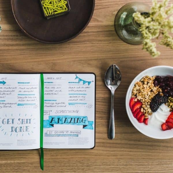 picture of food journal next to a plate of breakfast food