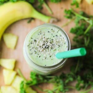 top angle of green parsley smoothie in a jar with green jar sprinkled with hemp seeds