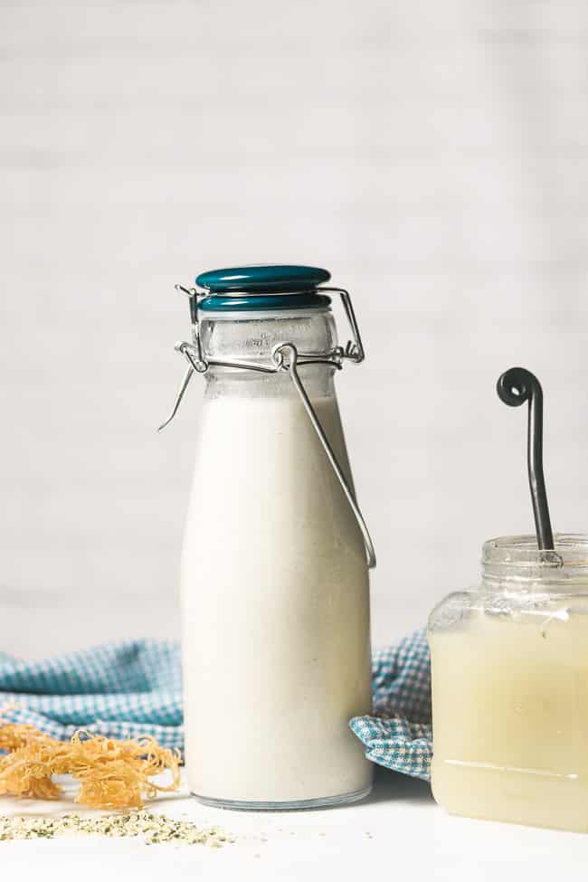 dairy free milk in a glass milk bottle next to sea moss gel