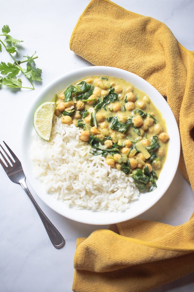 chickpea curry on a plate with white rice