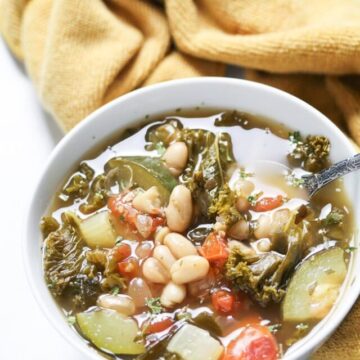 plant based soup in a white bowl with a spoon