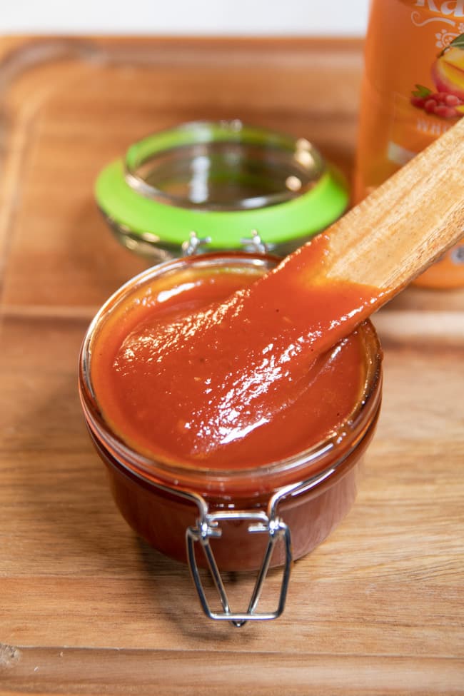 BBQ sauce in a jar with a wooden spoon in it