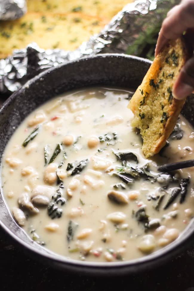 creamy white bean soup in a bowl with garlic bread