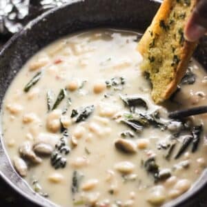 creamy white bean soup in a bowl with garlic bread