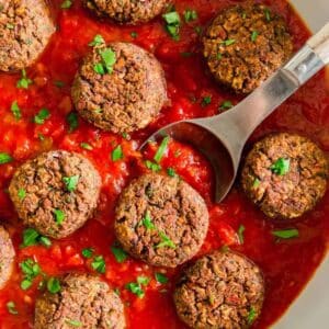 black bean balls in tomato sauce in pan