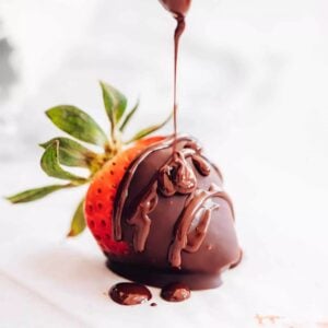 fresh strawberry covered with a chocolate drizzle