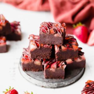 vegan fudge topped with fresh fresh strawberries on a gray plate