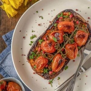 stuffed butternut squash with lentils and tomatoes on a vine