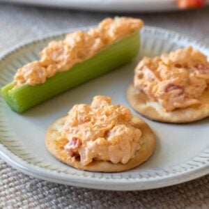 vegan pimento cheese on 2 crackers and a celery stick