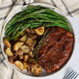 vegan steak next to potatoes and green beans