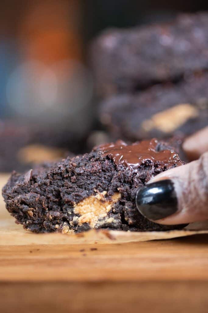 Gina Marie holding a brownie on the cutting board