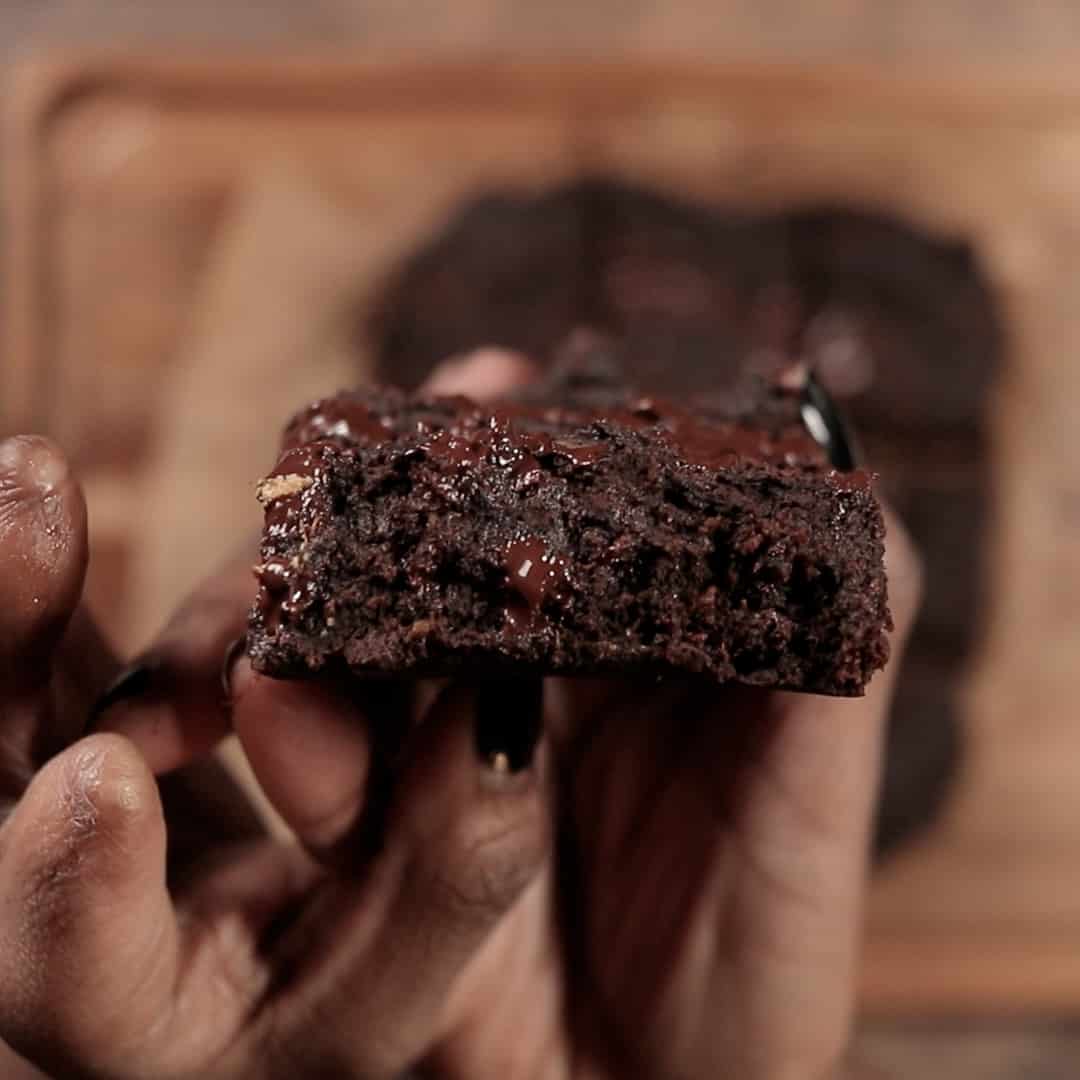 holding brownie in hand showing melted chocolate inside