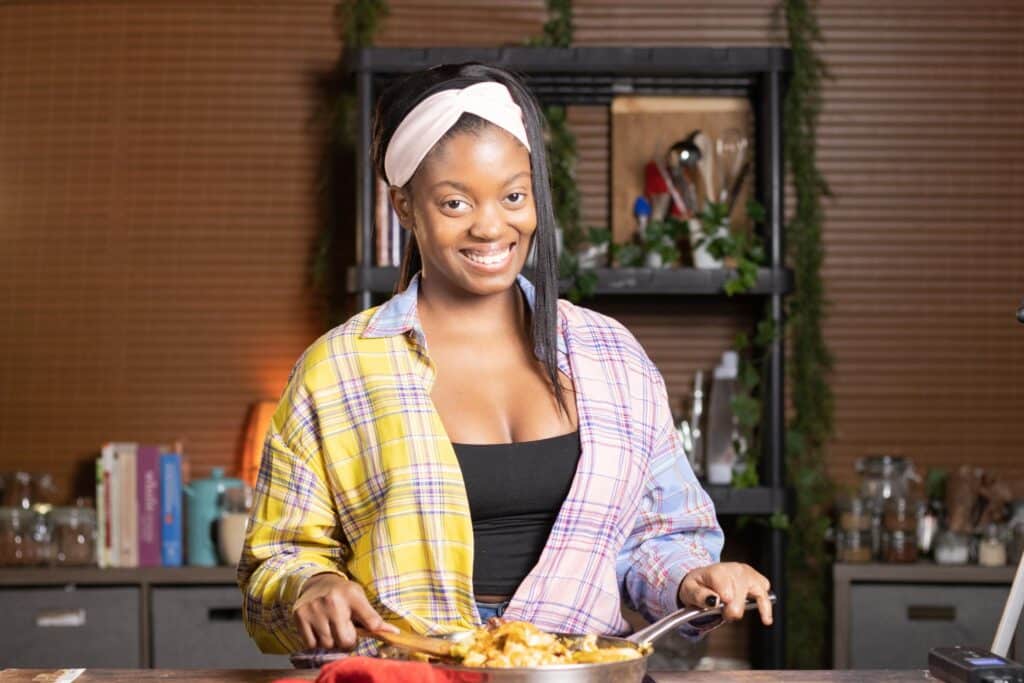 a photo of Gina Marie cooking the fried cabbage smiling