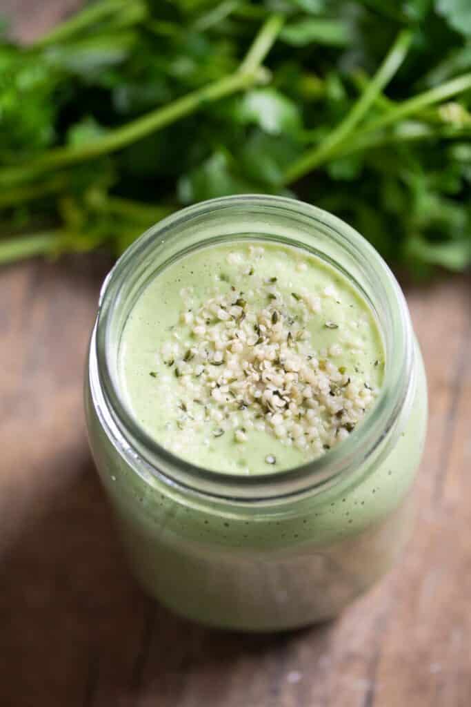 Parsley smoothie in a jar sprinkled with hemp seeds