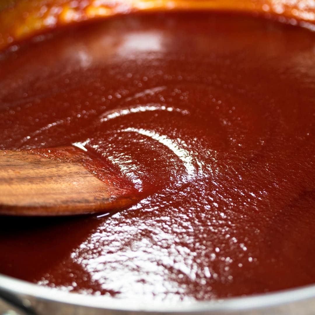 BBQ sauce in a pan with wooden ladle