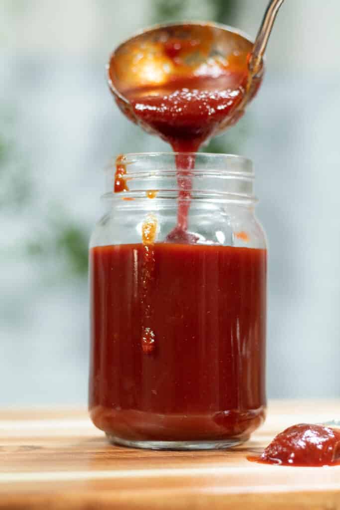 BBQ sauce being poured into a jar