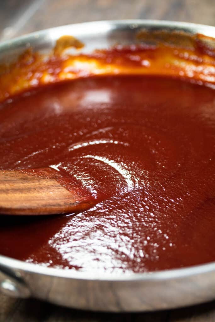 BBQ sauce in a pan with wooden ladle