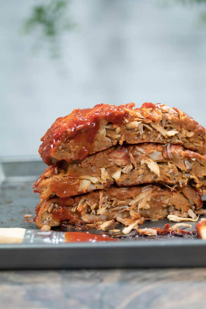 vegan ribs stacked on top of each other on a pan
