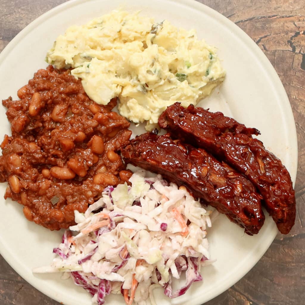 step 10 of serving ribs on a plate with other vegan bbq recipes