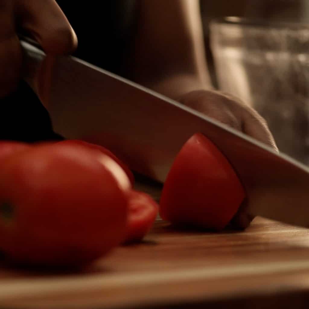 chopping tomatoes on a cutting board