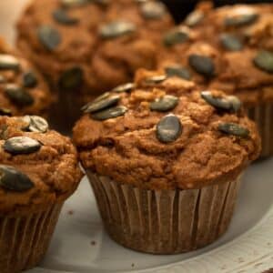 up close photo of pumpkin muffins on a white plate