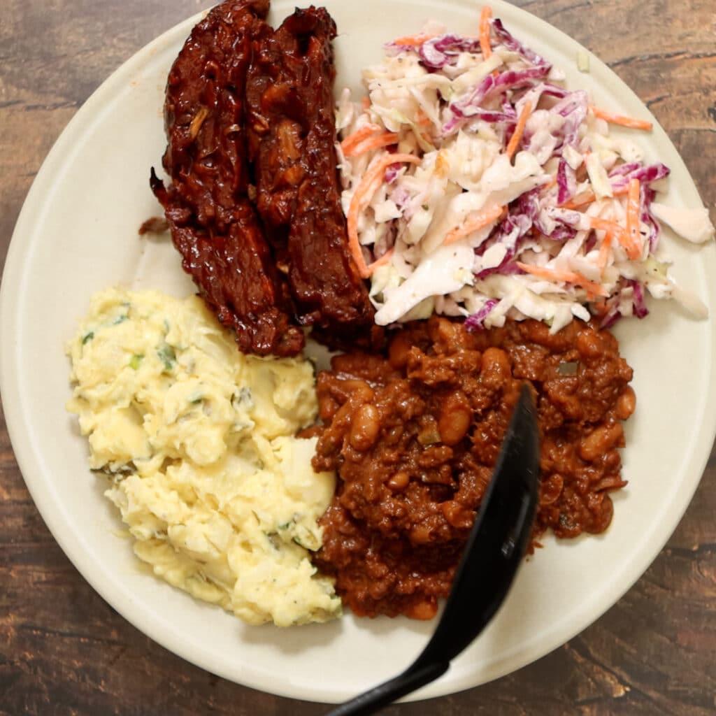 vegan baked beans served on a plate with other bbq recipes