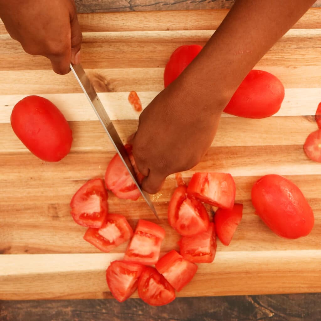 chop tomatoes on cutting