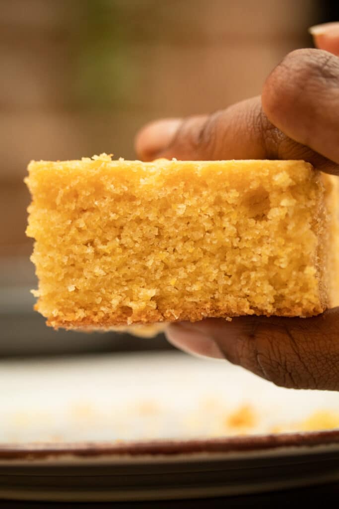 slice of cornbread being held in hand