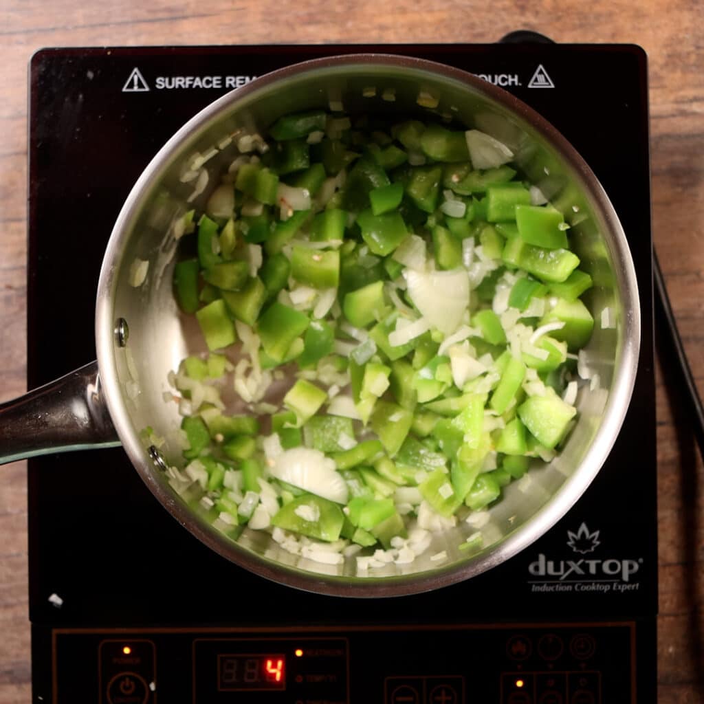sauté onions and peppers in a pot