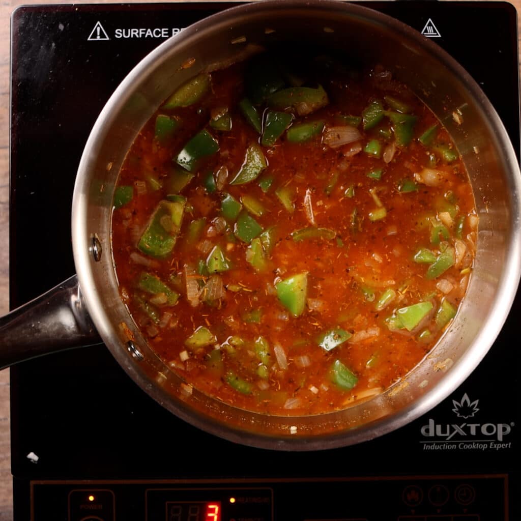 water in a pot with seasoned vegetables