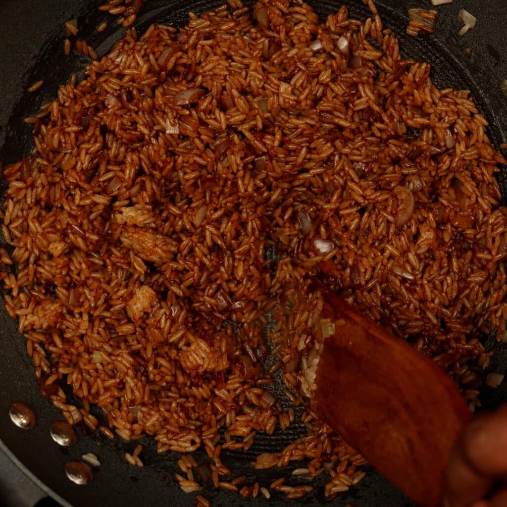 rice being sauté with dark soy sauce turned into a brown color
