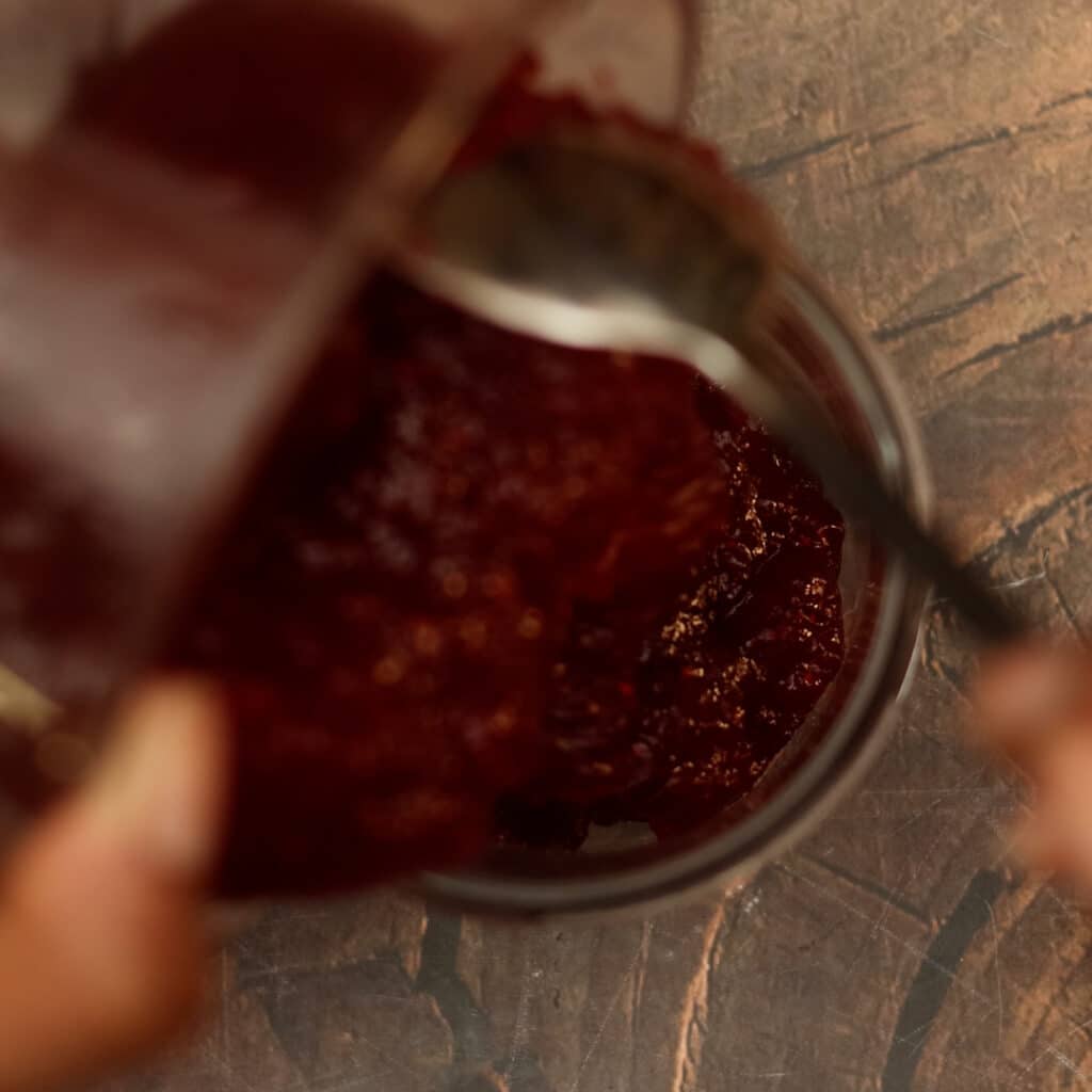 pouring cranberry sauce in mason jar
