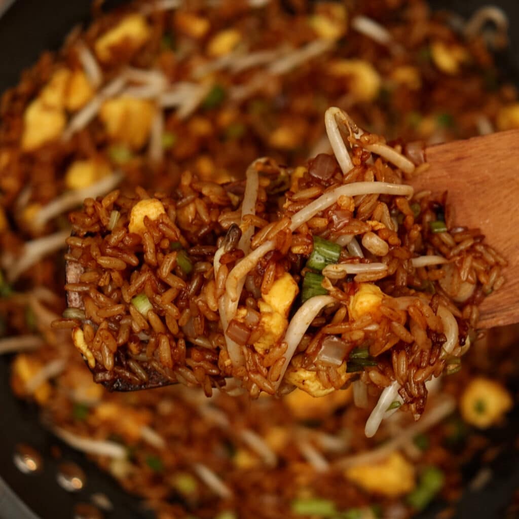 sauté veggies with rice in wok