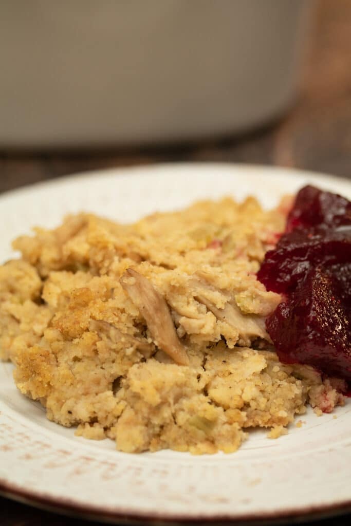 cornbread dressing on a plate with cranberry sauce