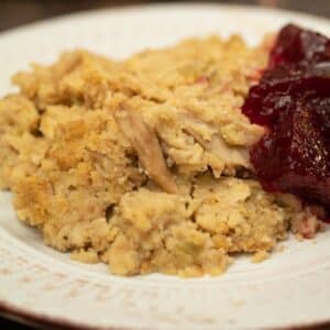 cornbread dressing on a plate with cranberry sauce
