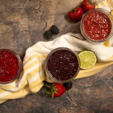 strawberry, blackberry, and raspberry chia jam in small mason jars