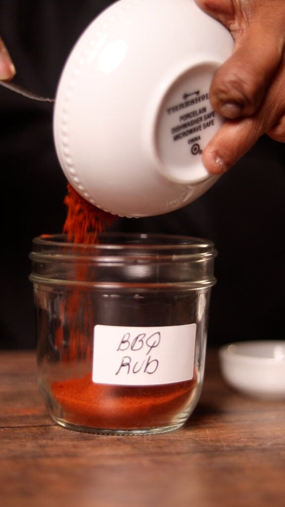 pouring seasonings into a mason jar