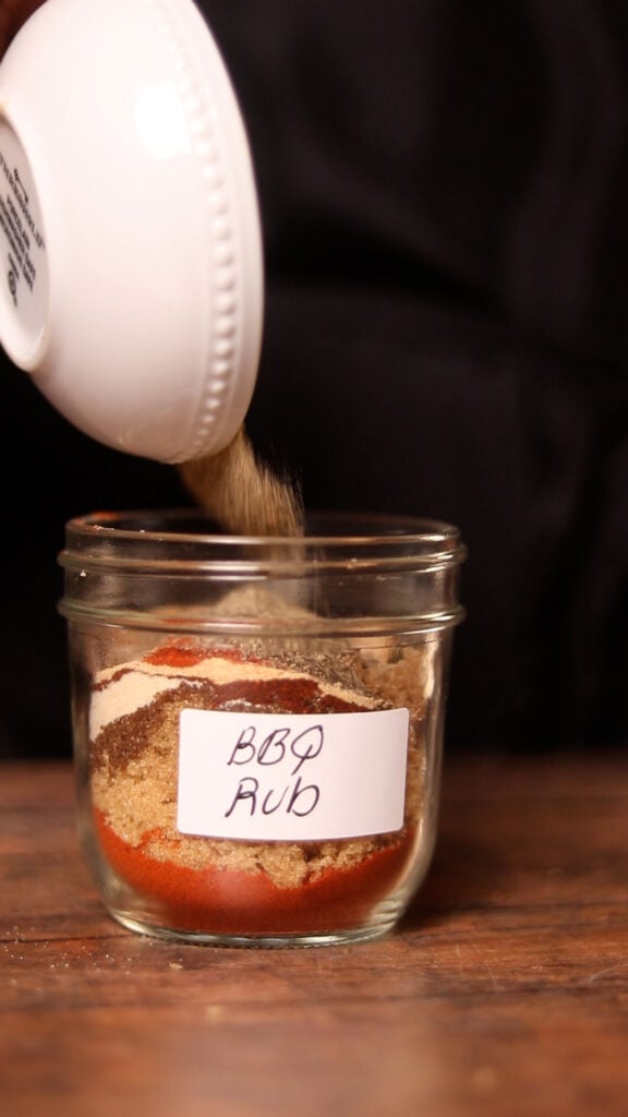 pouring seasonings into a mason jar