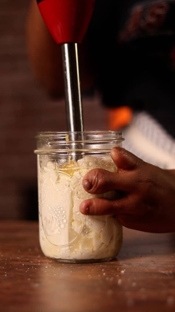 egg free mayo being blended with an immersion blender