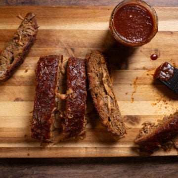 vegan ribs sliced on a cutting board with BBQ Sauce